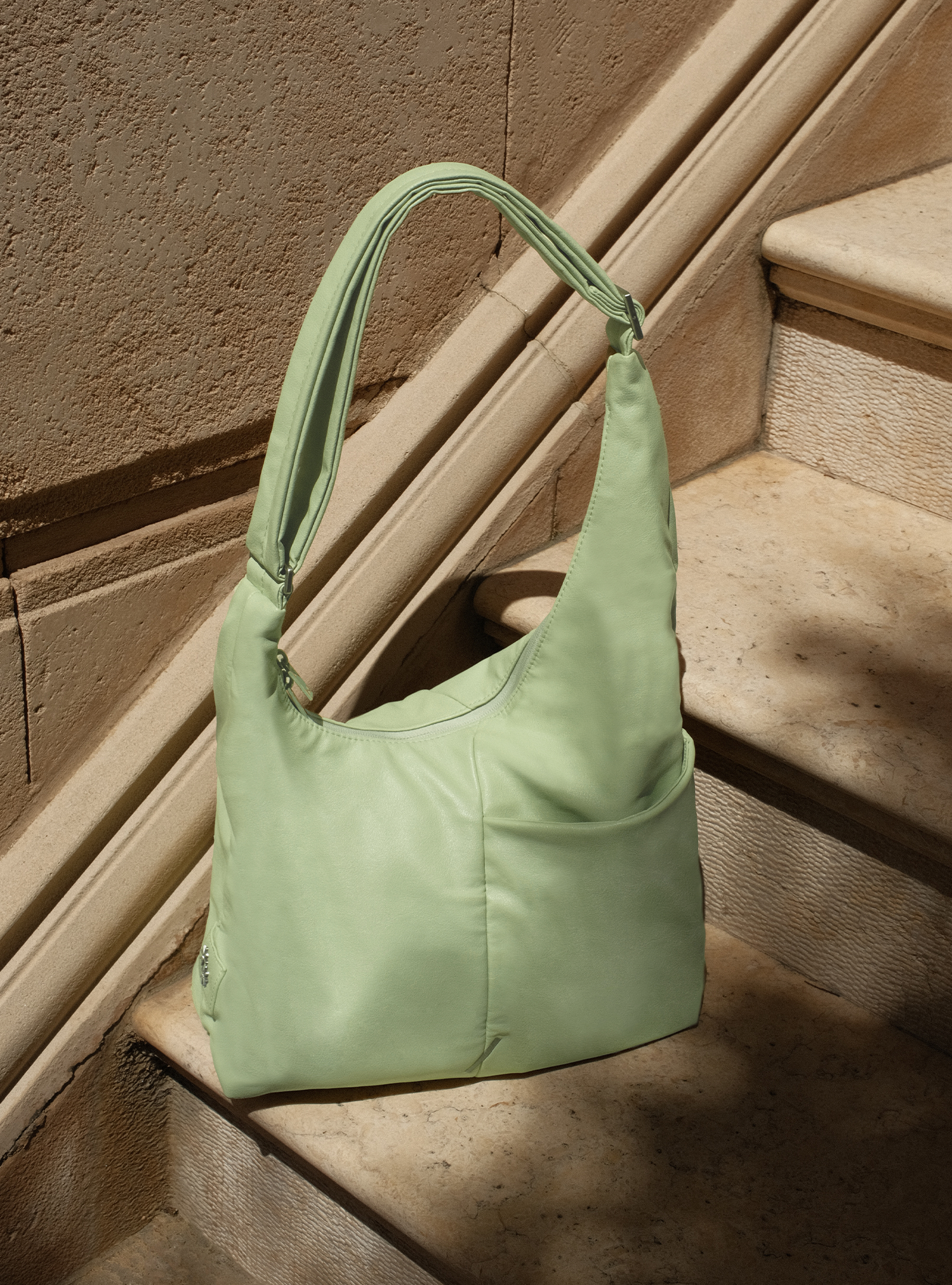 The Midi Arc slouchy hobo bag in pastel green vegan leather for work, travel and everyday use