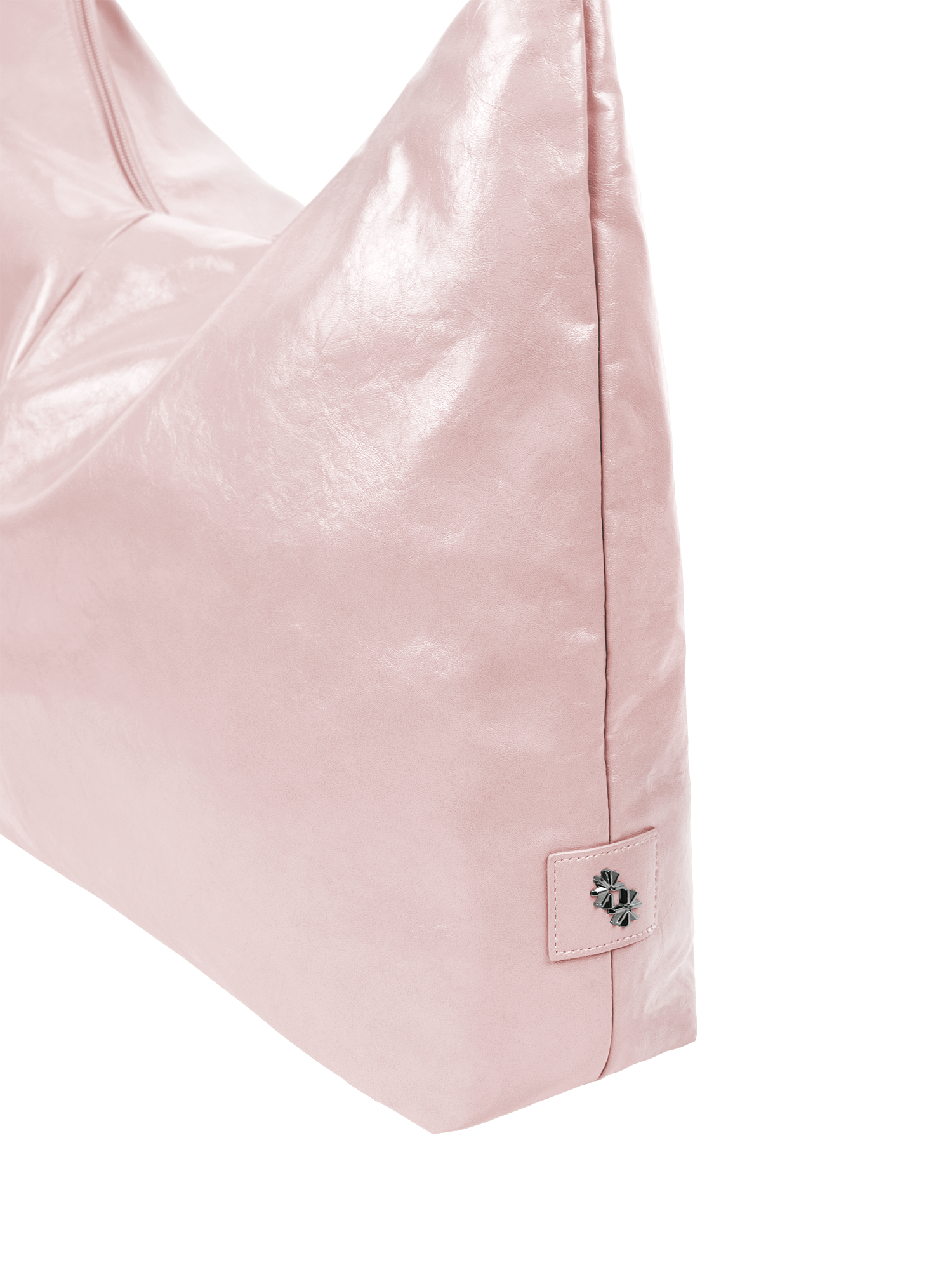 Close-up of the Arc hobo-style bag in pale pink vegan leather showing metal logo emblem