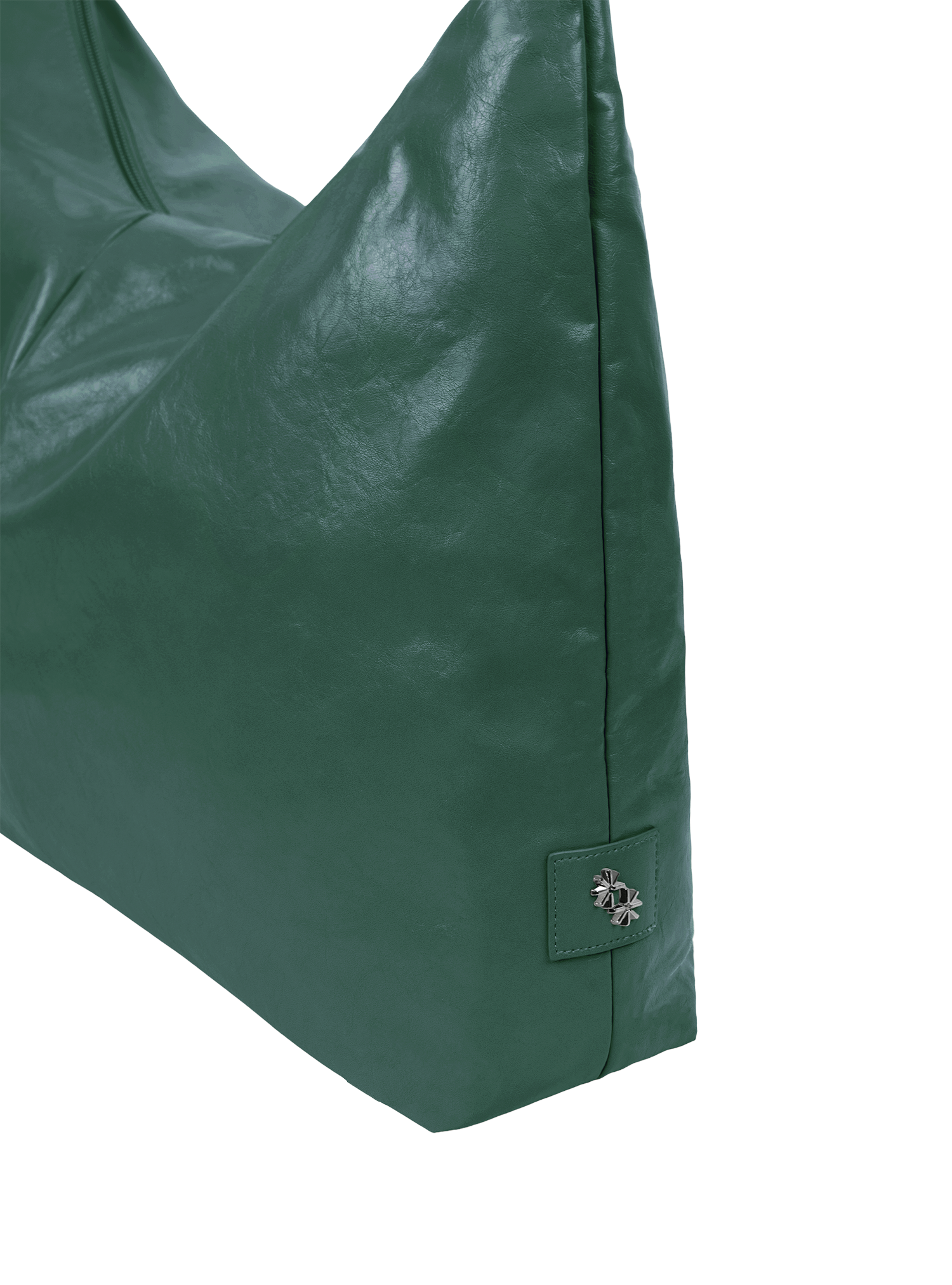Close-up of the Arc hobo-style bag in forest green vegan leather, showing metal logo emblem
