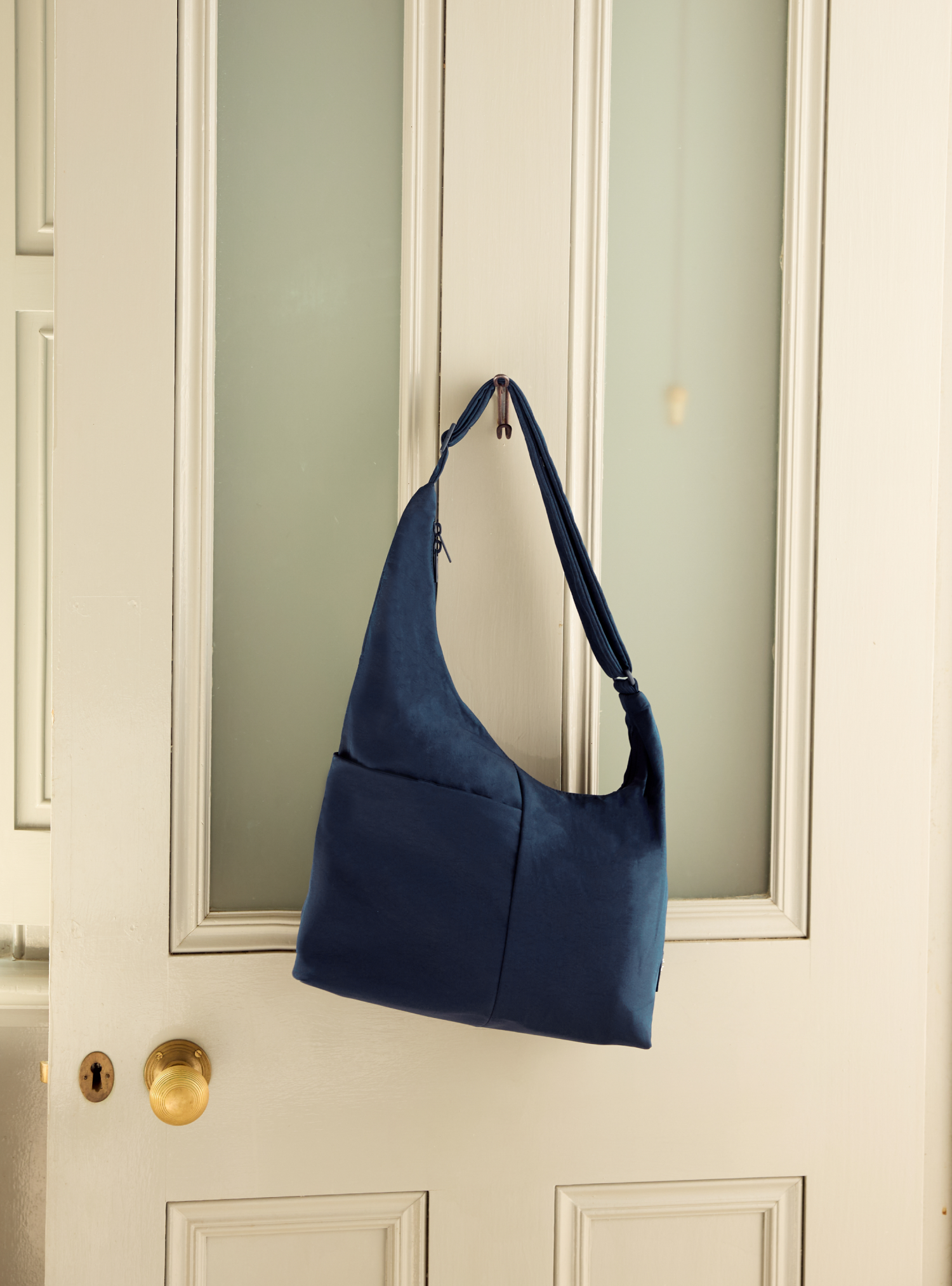 The Midi Arc slouchy hobo-style bag in navy nylon for work and everyday use