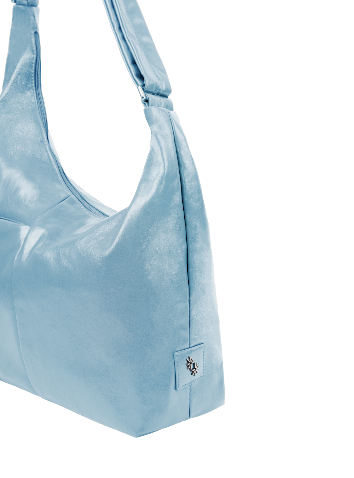 Close-up of the Midi Arc hobo-style bag in pale blue vegan leather, showing metal logo emblem