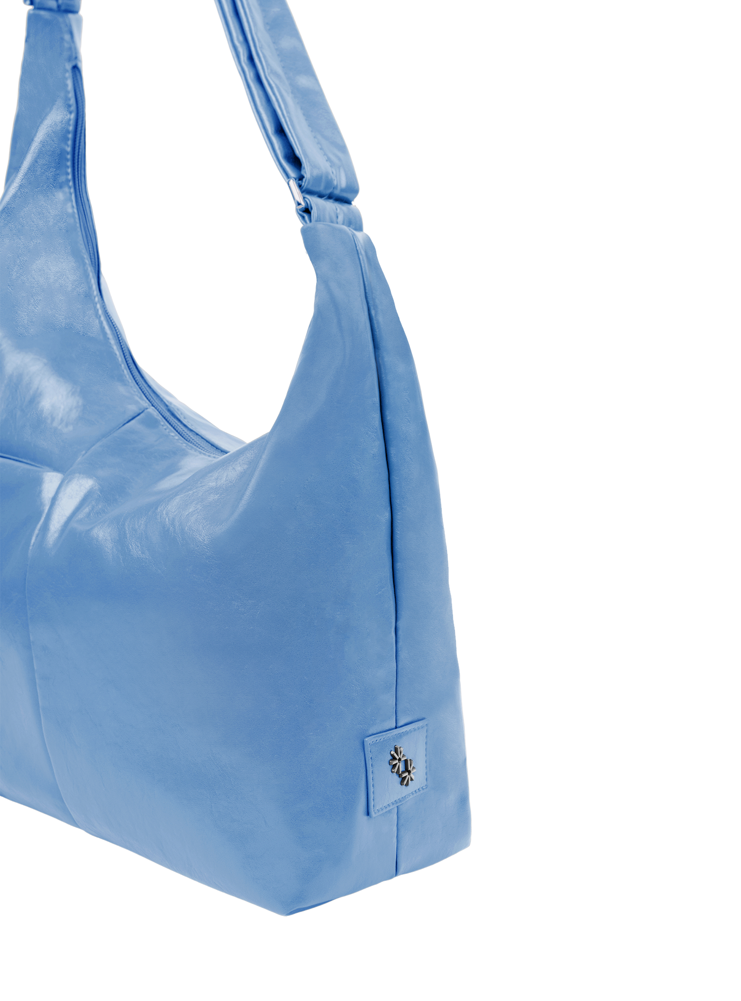 Close-up of the Midi Arc hobo-style bag in island blue vegan leather, showing metal logo emblem