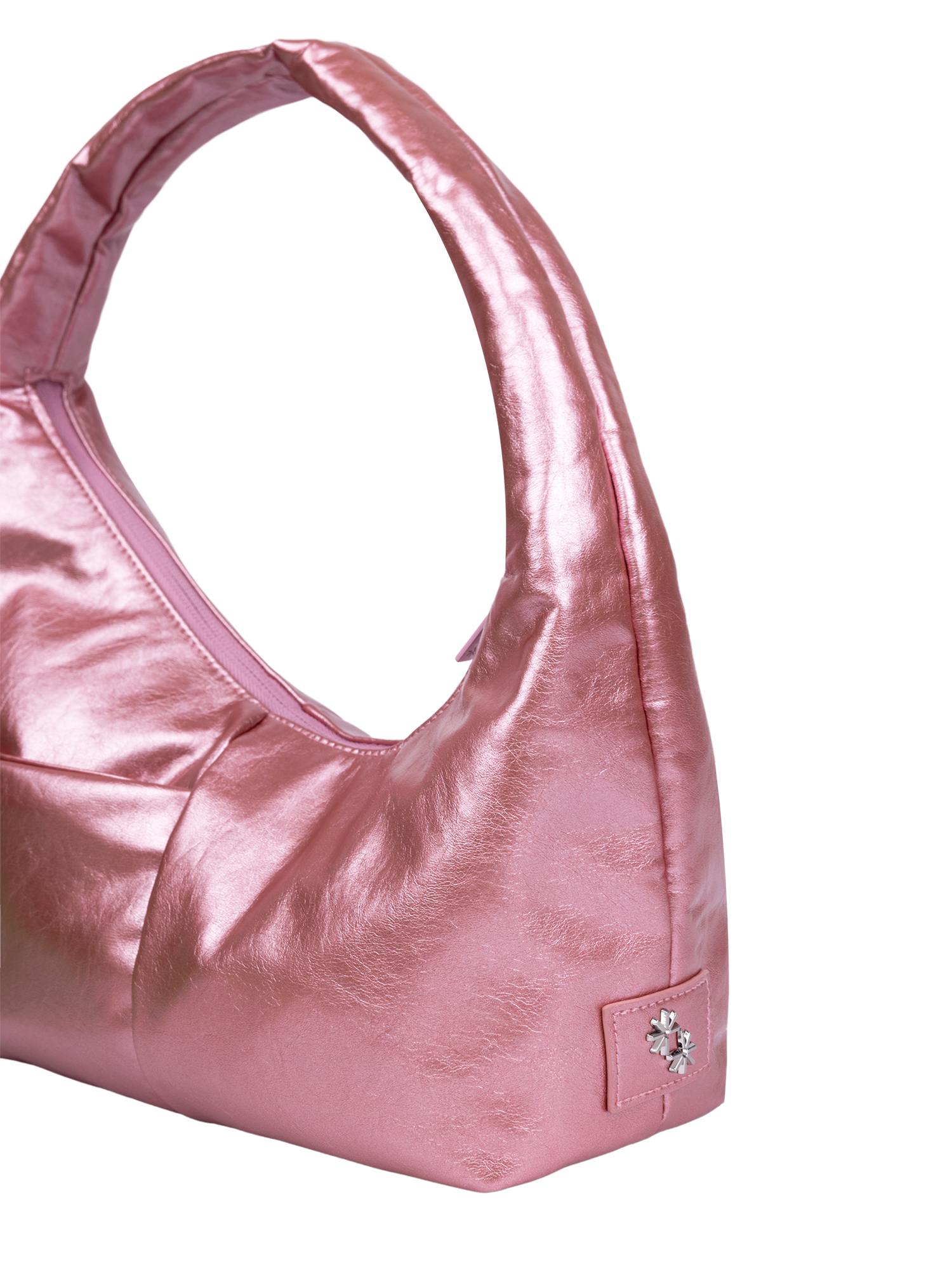 Close-up of the Mini Arc hobo-style shoulder bag in metallic pink vegan leather, showing metal logo emblem