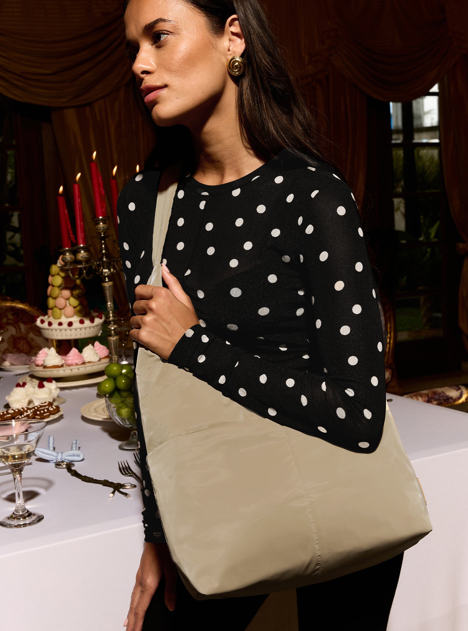 Woman carrying the Midi Arc slouchy hobo bag in camel beige polyester as crossbody wear
