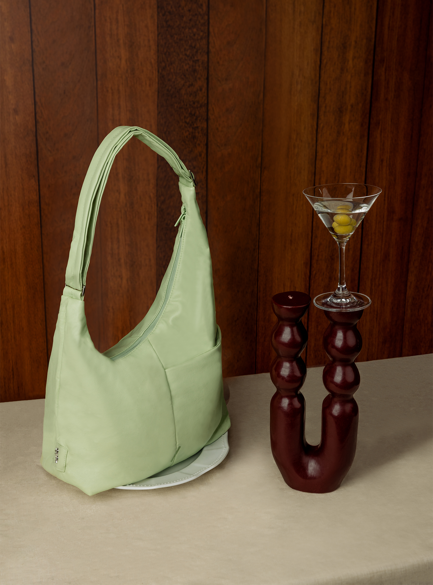 The Midi Arc slouchy hobo bag in pastel green vegan leather for work, travel and everyday use