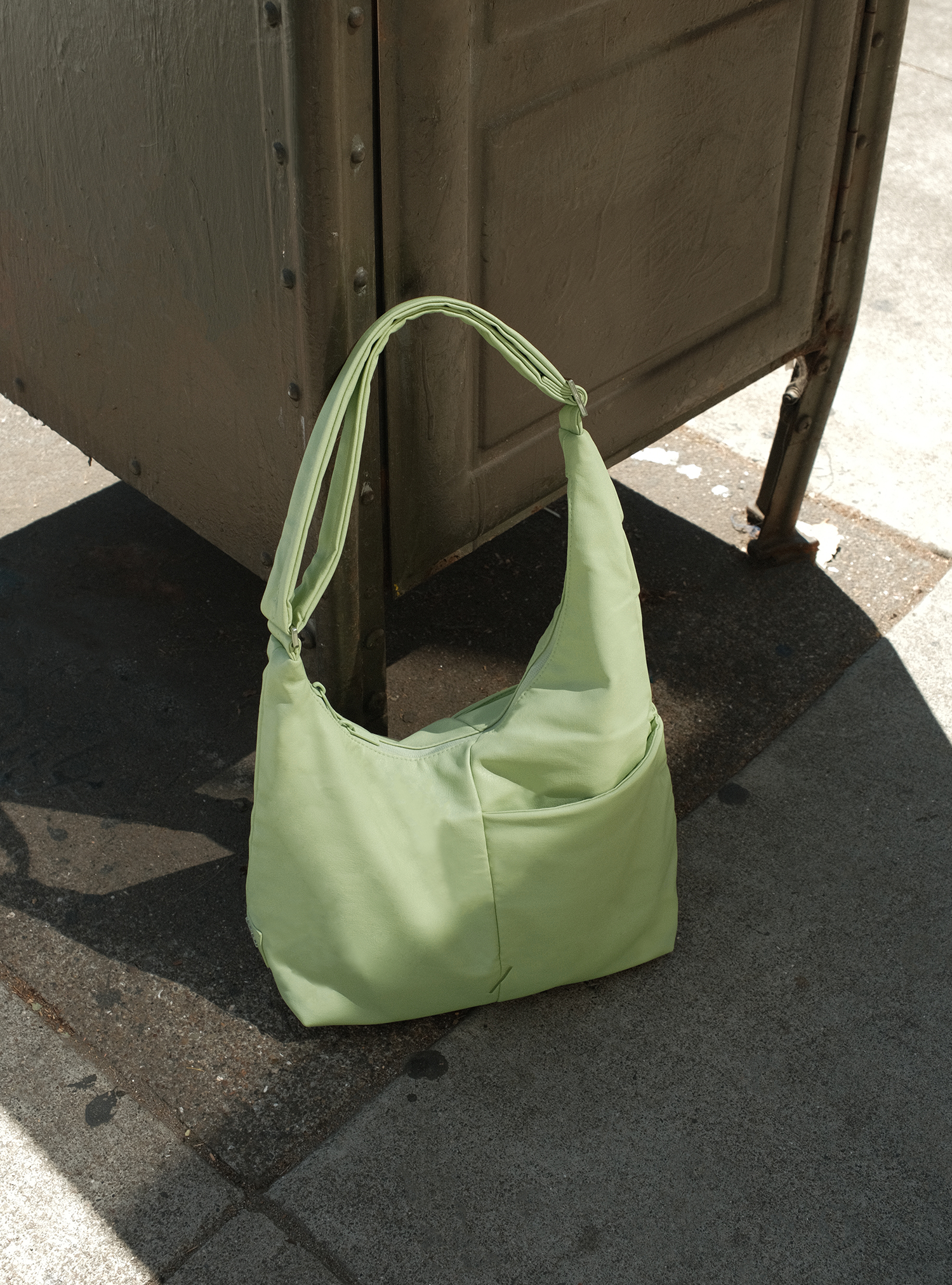 The Midi Arc slouchy hobo bag in pastel green vegan leather for work, travel and everyday use