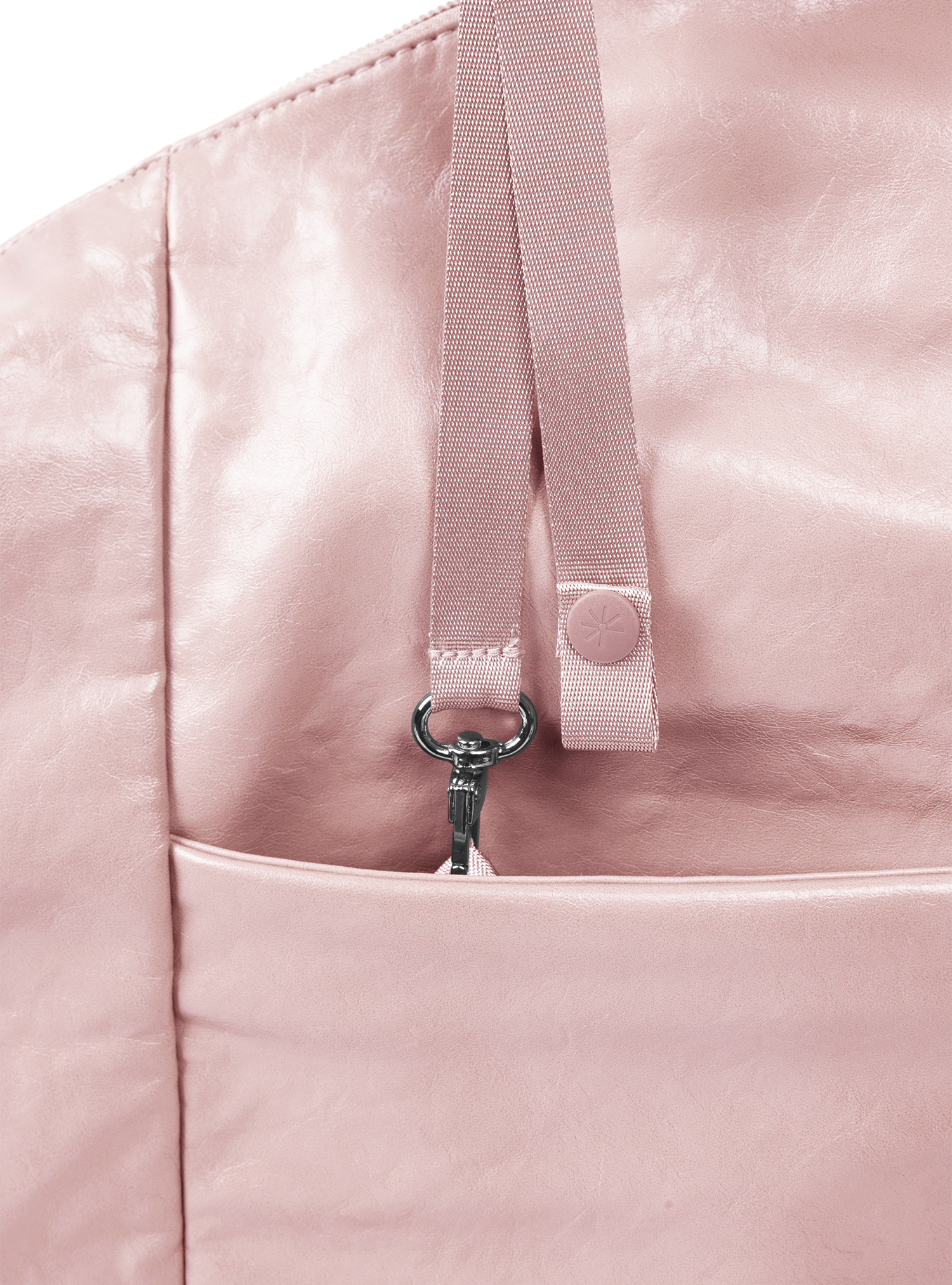 Exterior pocket of the Arc hobo-style bag in pale pink vegan leather, with concealed snap loop