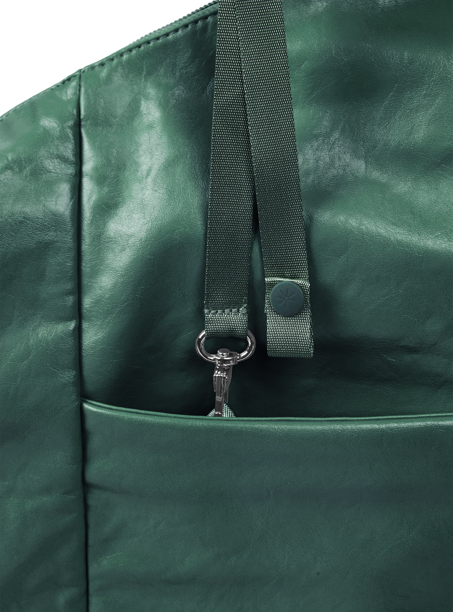 Exterior pocket of the Arc hobo-style bag in forest green vegan leather with concealed snap loop