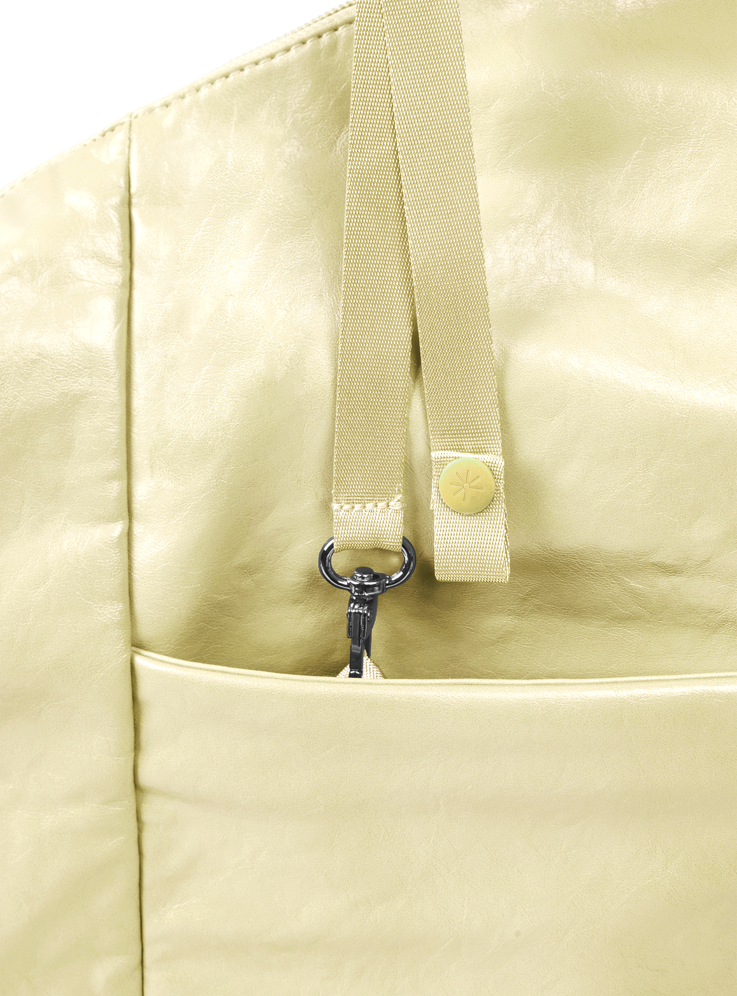 Exterior pocket of the Arc hobo-style bag in pale yellow vegan leather, with concealed snap loop