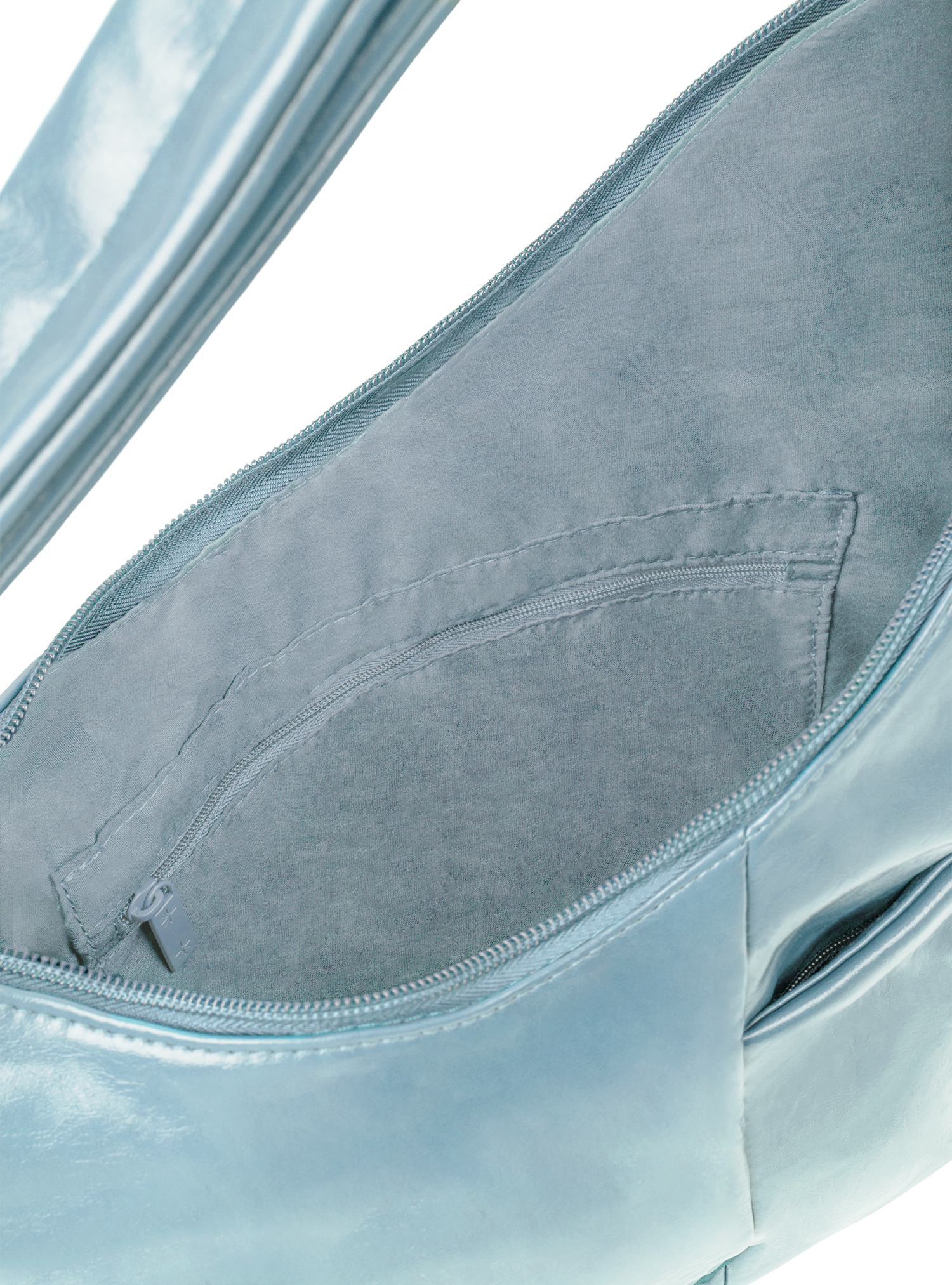 Interior of the Midi Arc hobo-style bag in pale blue vegan leather, with zipped interior pocket