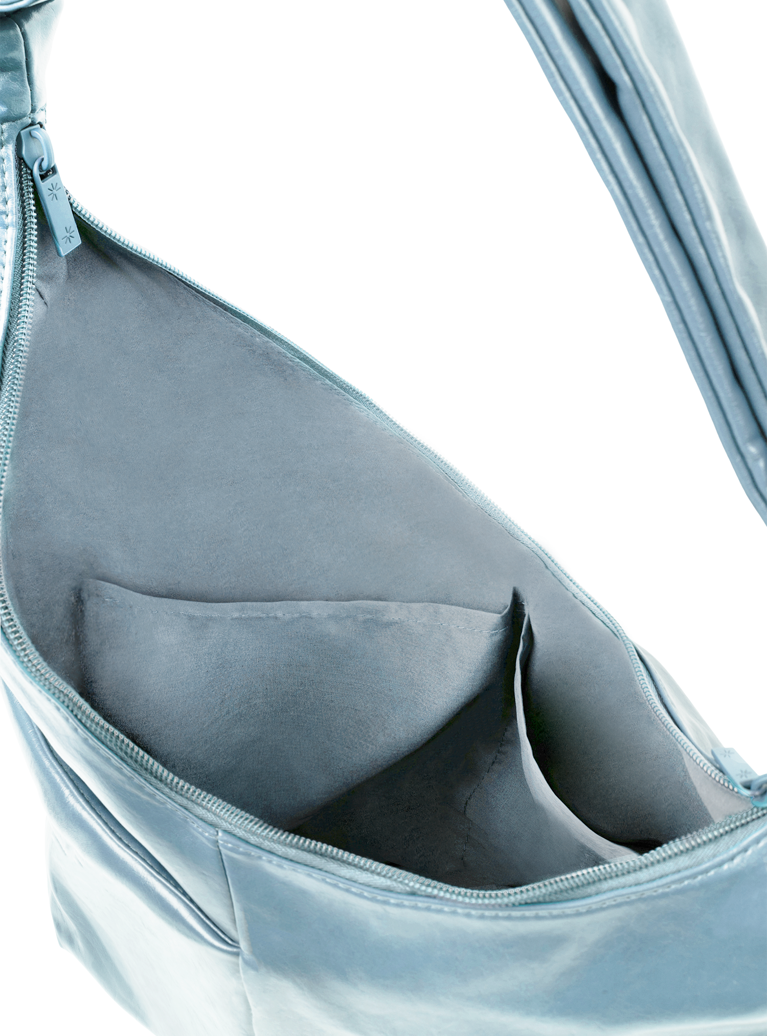 Interior of the Midi Arc hobo-style bag in pale blue vegan leather, with multiple pockets