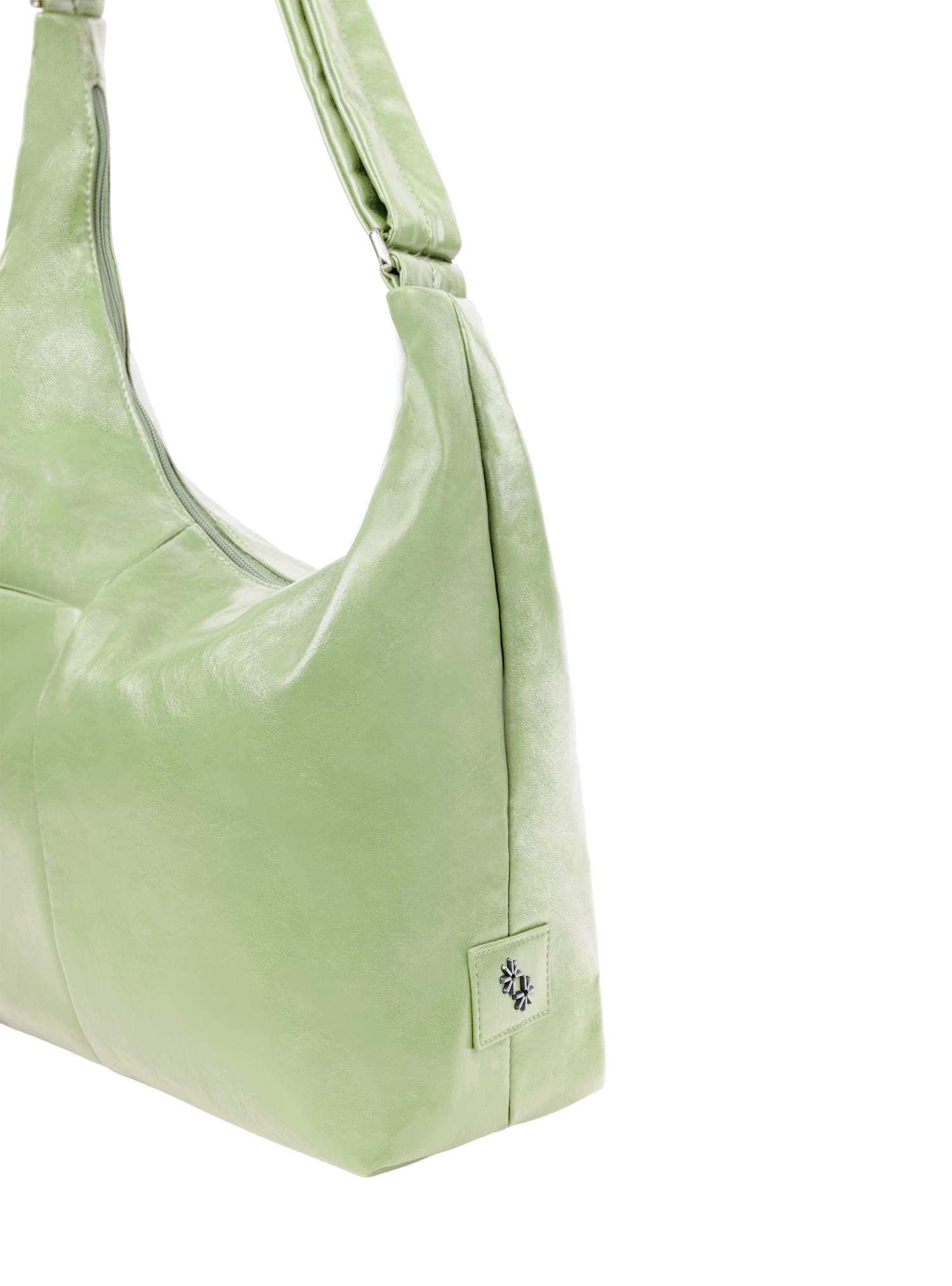 The Midi Arc slouchy hobo-style bag in pastel green vegan leather with adjustable shoulder strap
