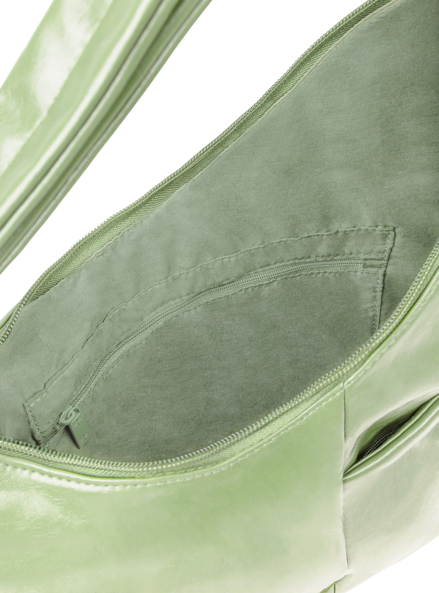 Interior of the Midi Arc hobo-style bag in pastel green vegan leather, with zipped interior pocket